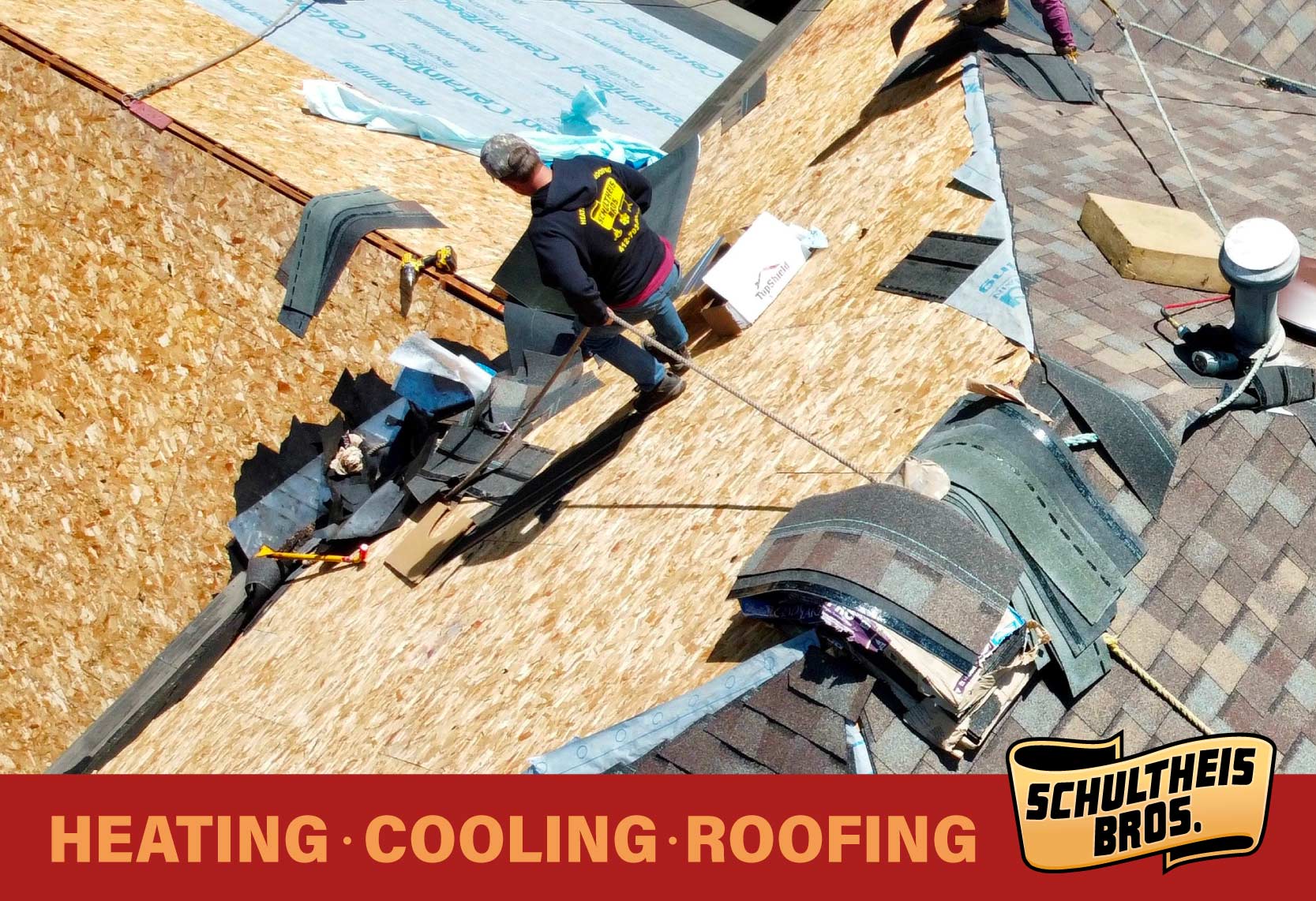 Roofers installing shingles on a roof