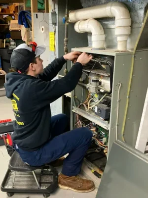 Schultheis Bros technician doing furnace repair and maintenance