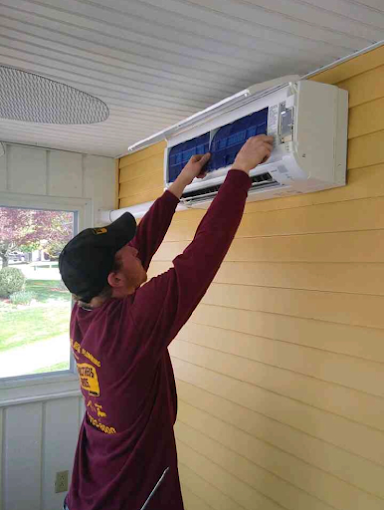 Schultheis Bros technician installing a ductless heat pump and air system